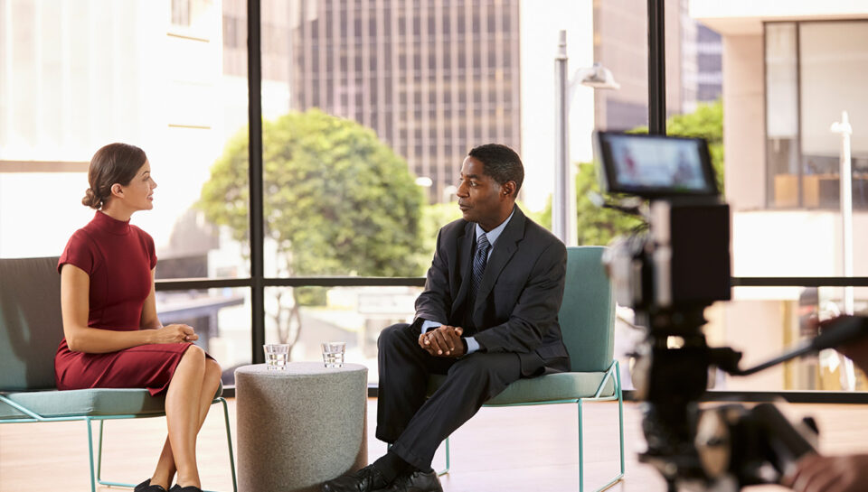 black-man-and-white-woman-on-set-filming-a-tv